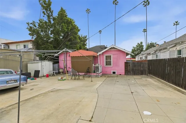 a backyard of a house with sofas fire pit and outdoor seating