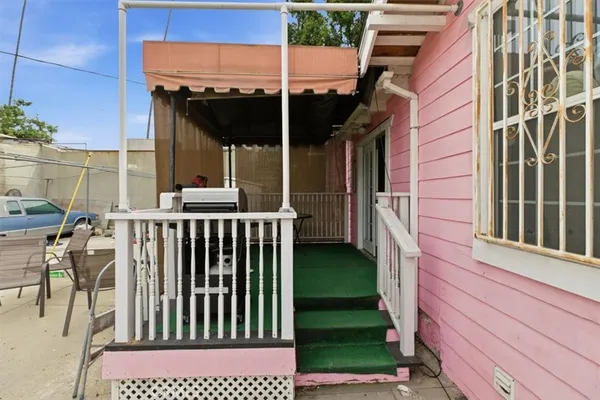 a view of a porch with a table and chairs