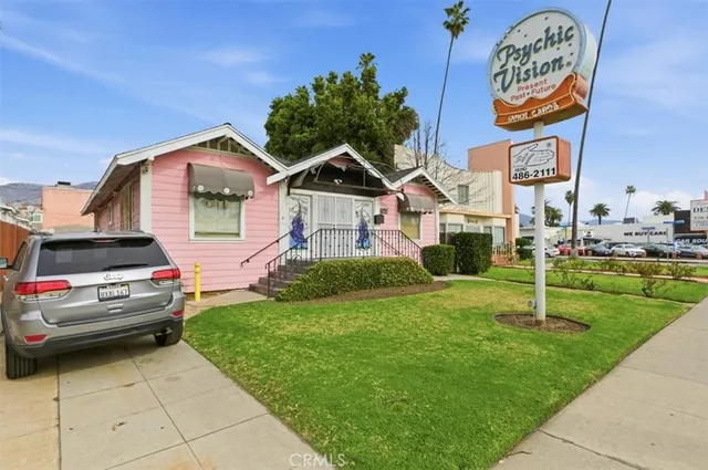 a front view of a house with a garden