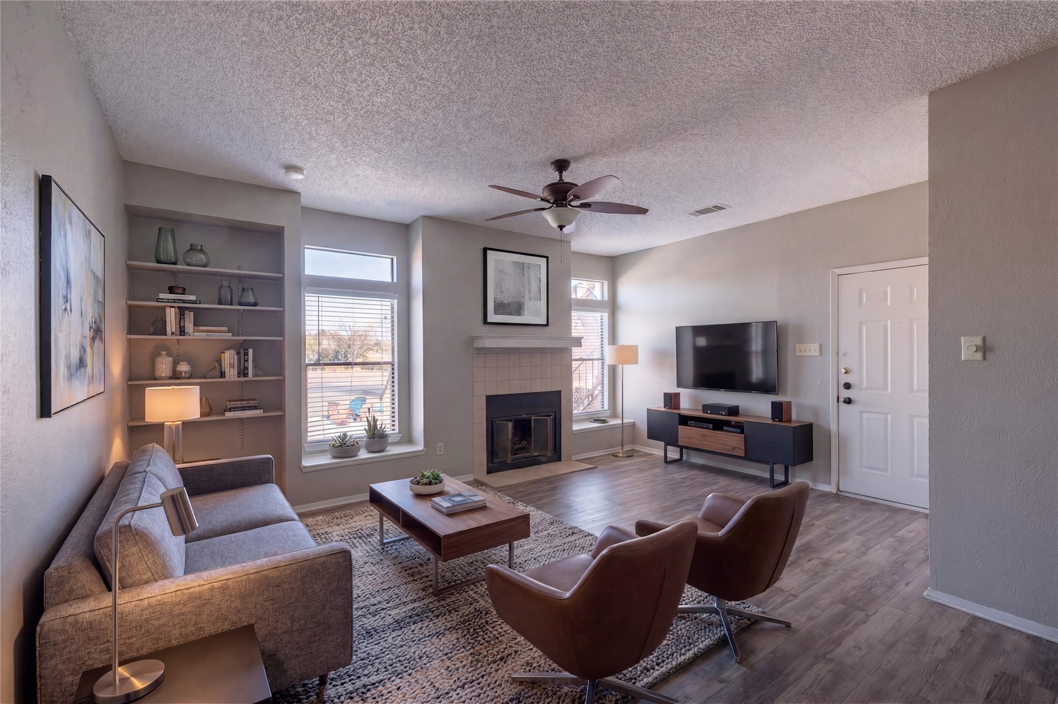 5305 Indio Cove, Unit B Austin, TX 78745 - Photo 1 of 19 a living room with furniture a fireplace and a flat screen tv