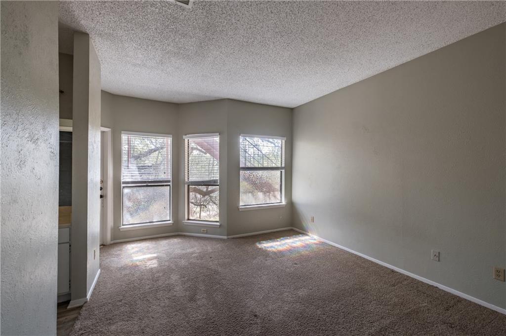 5305 Indio Cove, Unit B Austin, TX 78745 - Photo 12 of 19 an empty room with large windows