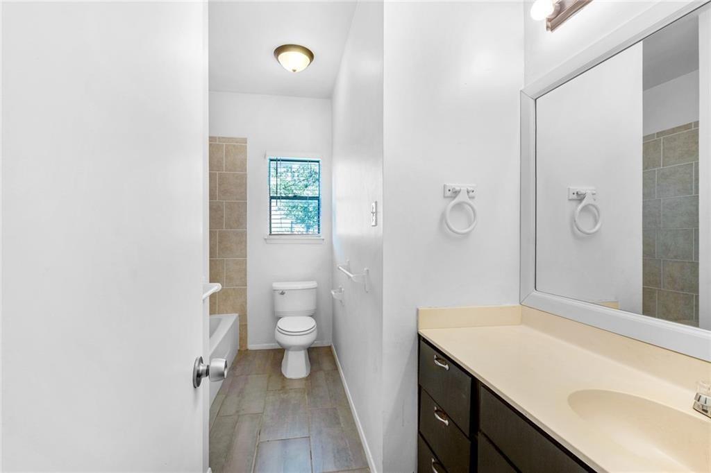5305 Indio Cove, Unit B Austin, TX 78745 - Photo 18 of 19 a bathroom with a sink a toilet and shower