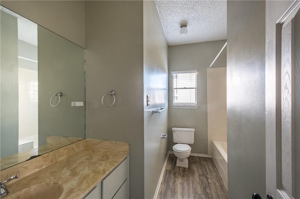 5305 Indio Cove, Unit B Austin, TX 78745 - Photo 5 of 19 a bathroom with a granite countertop sink a toilet and shower