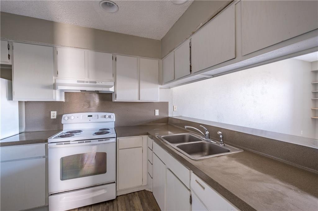 5305 Indio Cove, Unit B Austin, TX 78745 - Photo 6 of 19 a kitchen with white cabinets sink and white appliances