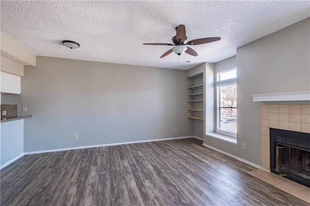 5305 Indio Cove, Unit B Austin, TX 78745 - Photo 9 of 19 a view of empty room with wooden floor and fireplace