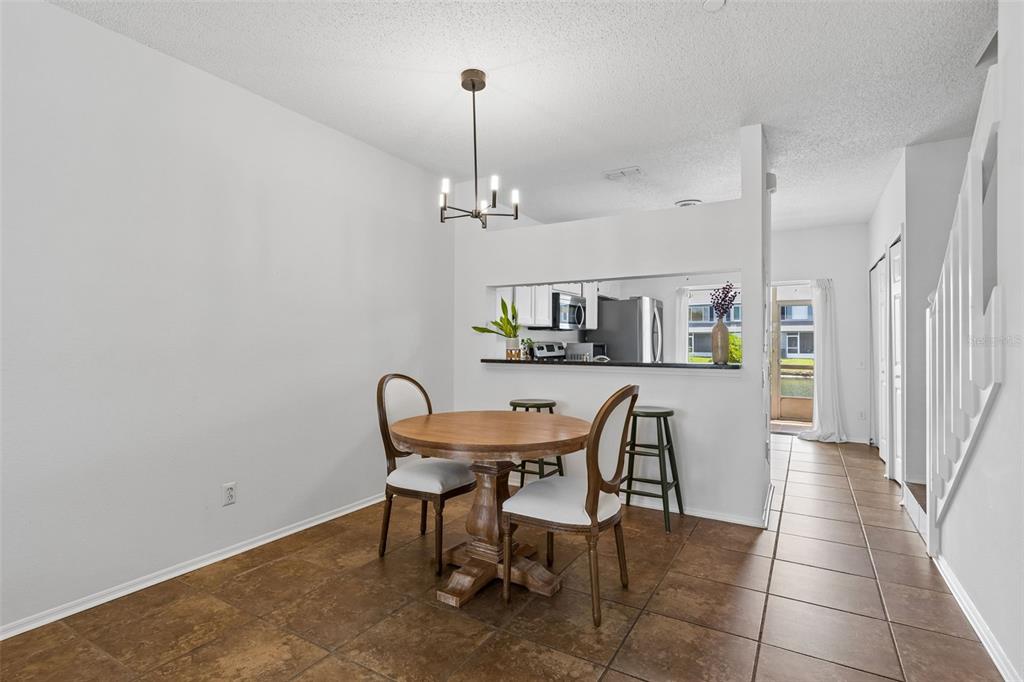 382 Countryside Key Boulevard Oldsmar, FL 34677 - Photo 10 of 58 a view of a dining room with furniture and wooden floor