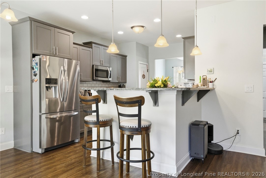240 Meherrin Loop Raeford, NC 28376 - Photo 15 of 50 a kitchen with refrigerator and chairs