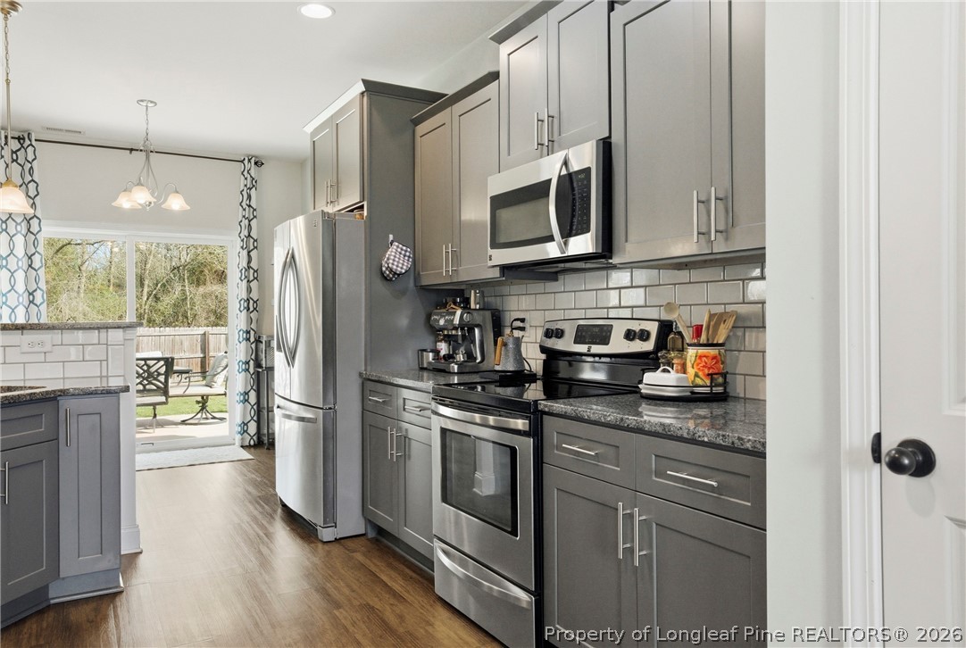 240 Meherrin Loop Raeford, NC 28376 - Photo 18 of 50 a kitchen with stainless steel appliances granite countertop a refrigerator stove and sink