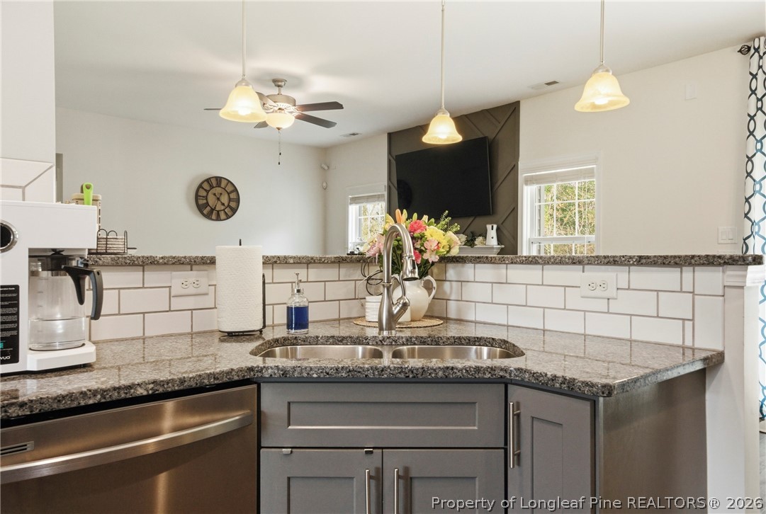 240 Meherrin Loop Raeford, NC 28376 - Photo 19 of 50 a kitchen with a sink and a clock on the wall