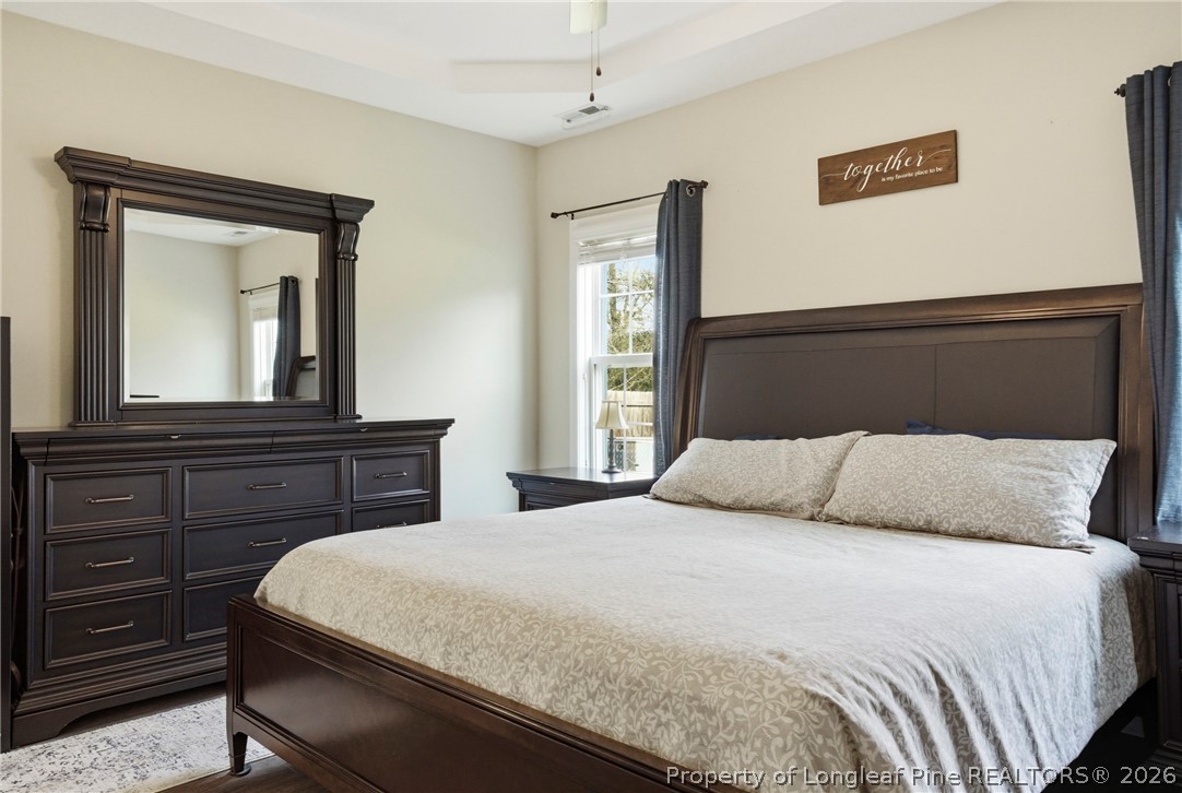 240 Meherrin Loop Raeford, NC 28376 - Photo 23 of 50 a bedroom with a large bed and a dresser