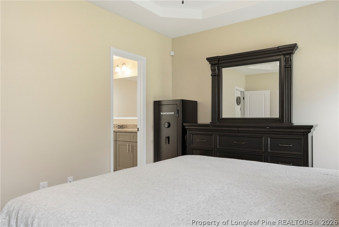 240 Meherrin Loop Raeford, NC 28376 - Photo 26 of 50 a bedroom with a bed and a mirror on dresser