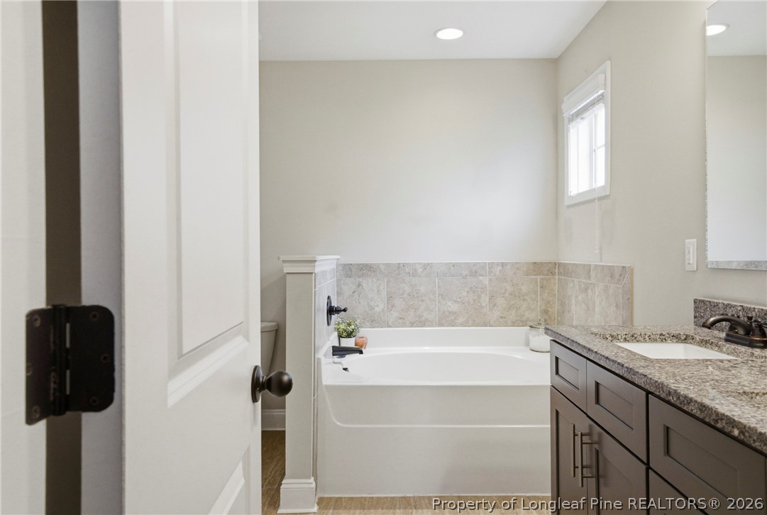 240 Meherrin Loop Raeford, NC 28376 - Photo 27 of 50 a bathroom with a granite countertop bathtub shower and sink