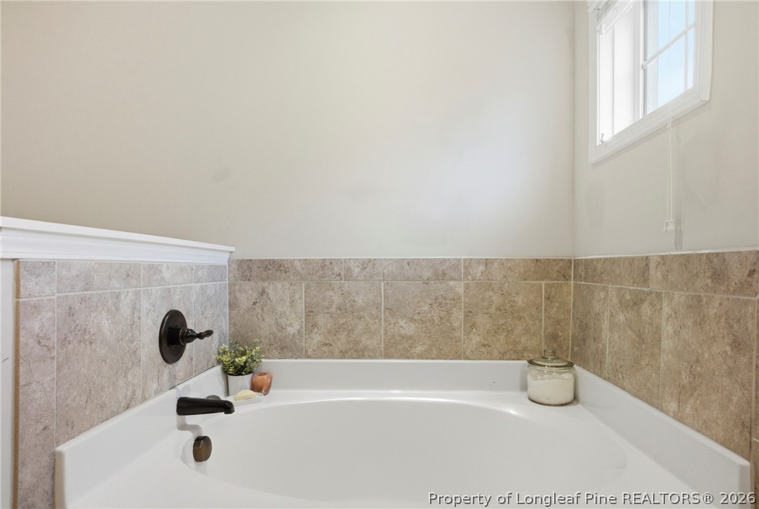 240 Meherrin Loop Raeford, NC 28376 - Photo 31 of 50 a bathroom with a bathtub