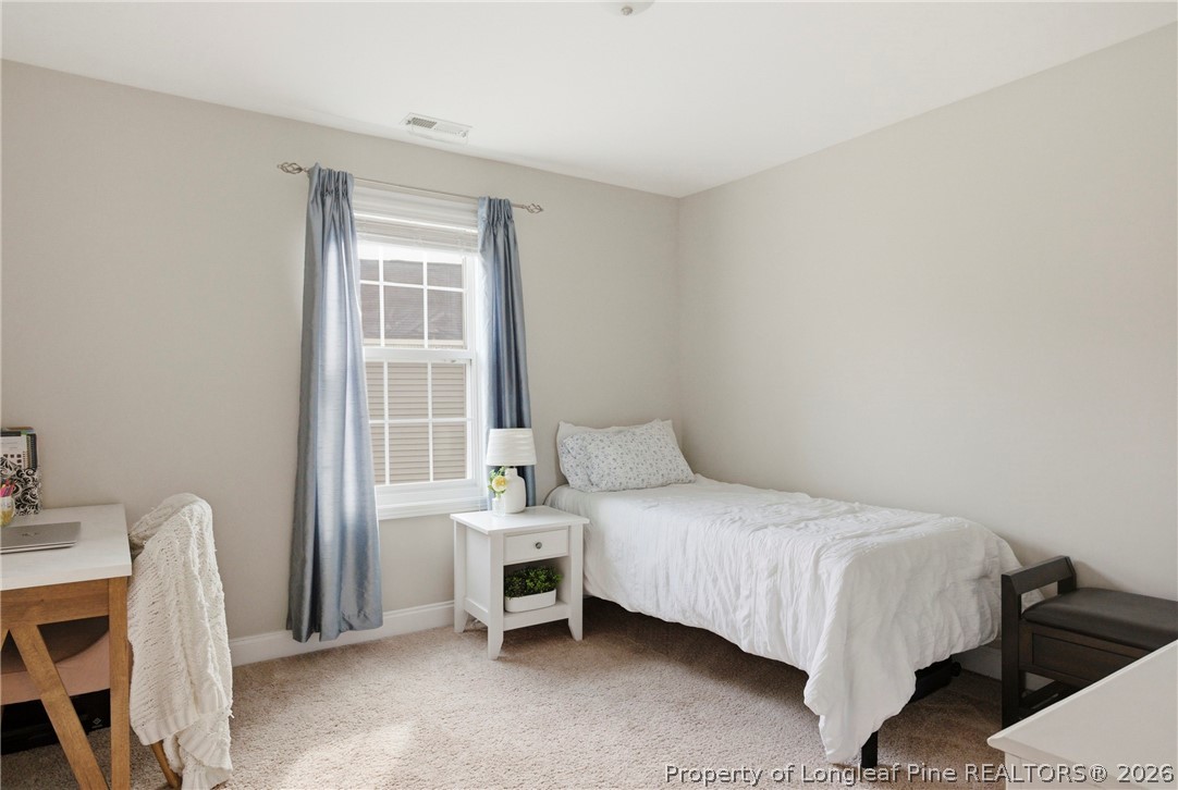 240 Meherrin Loop Raeford, NC 28376 - Photo 32 of 50 a bedroom with a bed and a window