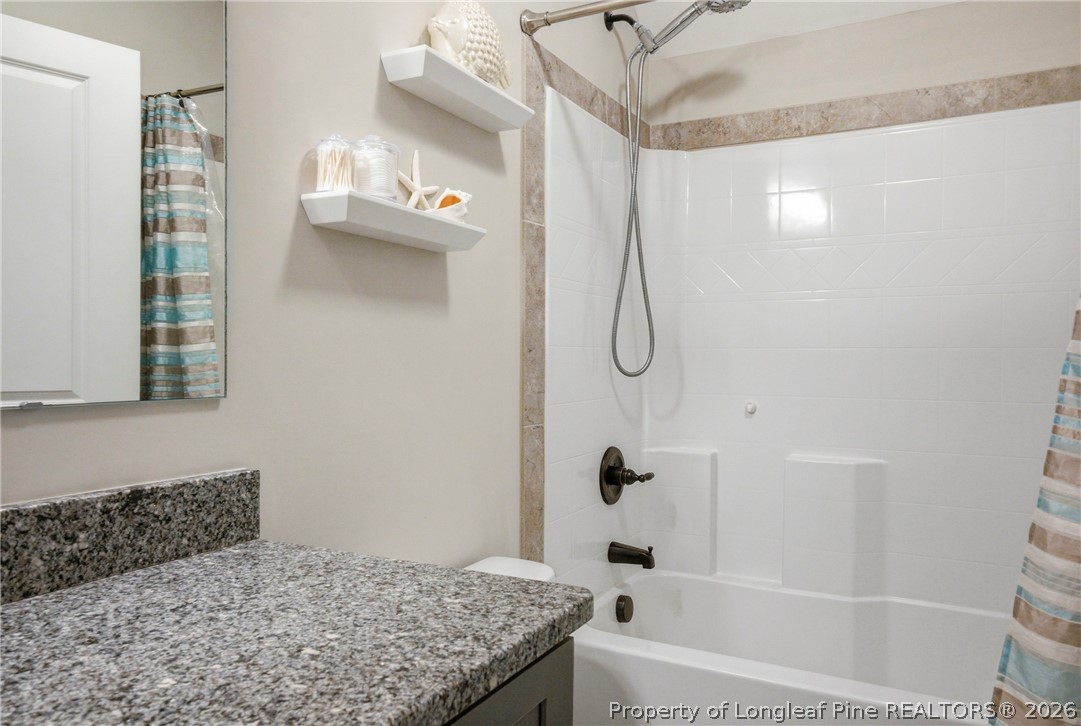 240 Meherrin Loop Raeford, NC 28376 - Photo 36 of 50 a bathroom with a granite countertop shower a sink and a bathtub