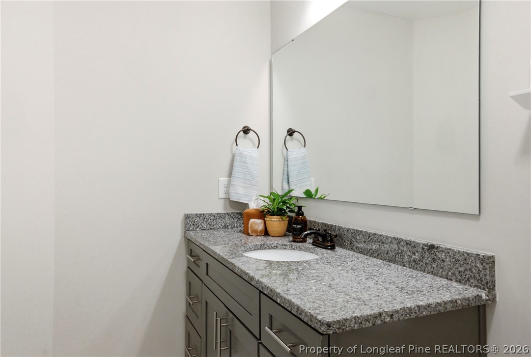 240 Meherrin Loop Raeford, NC 28376 - Photo 37 of 50 a bathroom with a granite countertop sink and a mirror