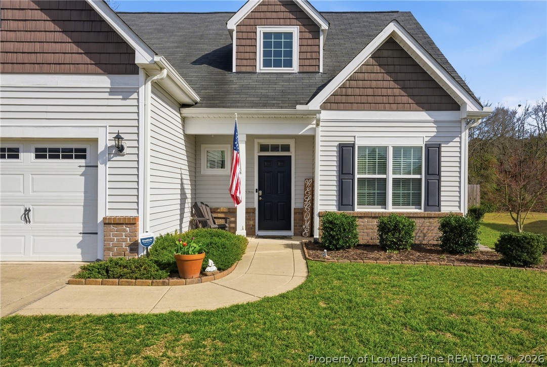 240 Meherrin Loop Raeford, NC 28376 - Photo 4 of 50 a front view of a house with a yard and garage