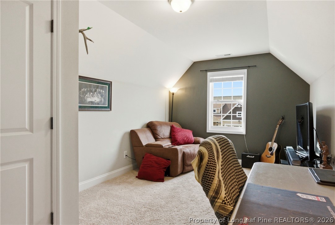 240 Meherrin Loop Raeford, NC 28376 - Photo 45 of 50 a living room with furniture a flat screen tv and a window