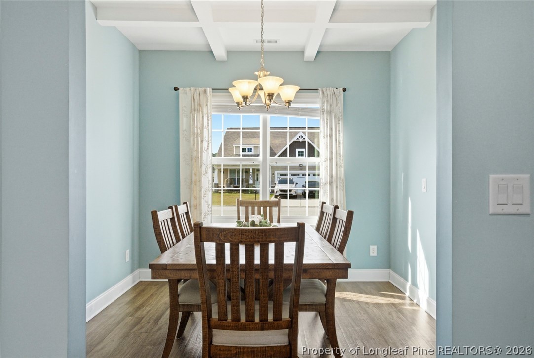 240 Meherrin Loop Raeford, NC 28376 - Photo 7 of 50 a view of a dining room with furniture a chandelier and wooden floor