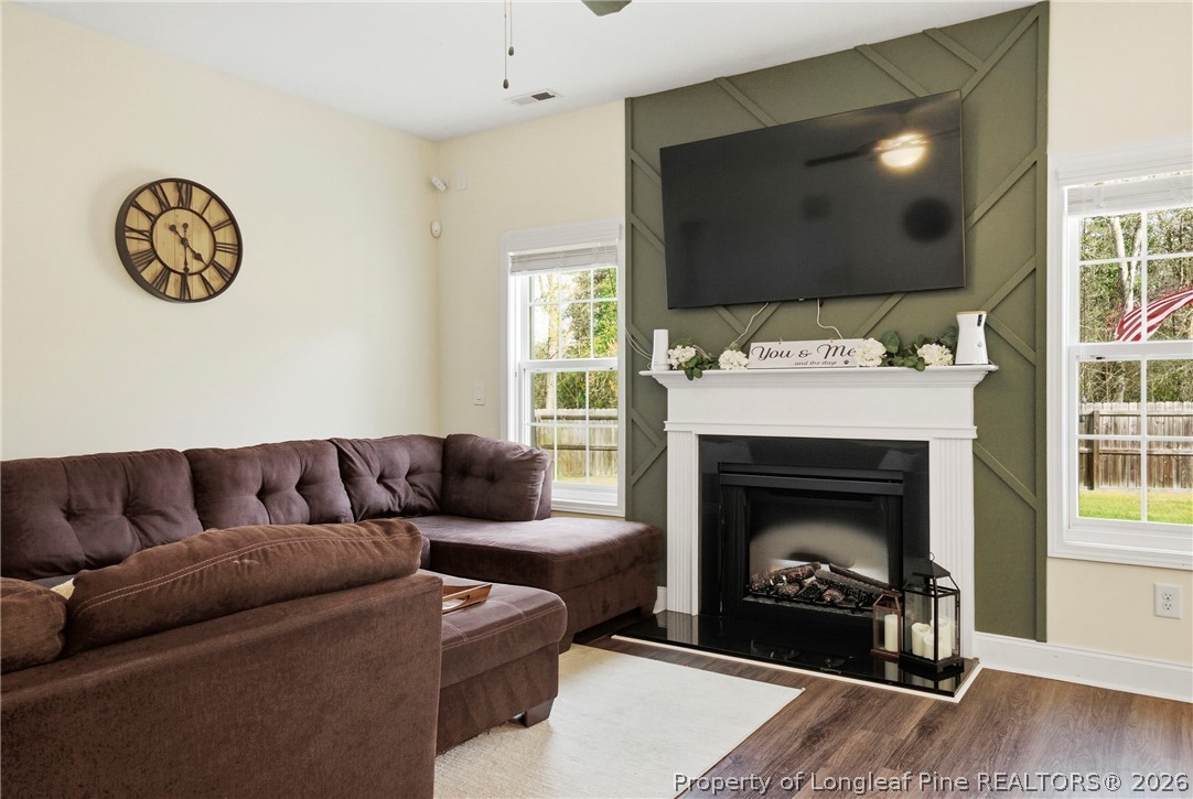 240 Meherrin Loop Raeford, NC 28376 - Photo 10 of 50 a living room with furniture a flat screen tv and a fireplace