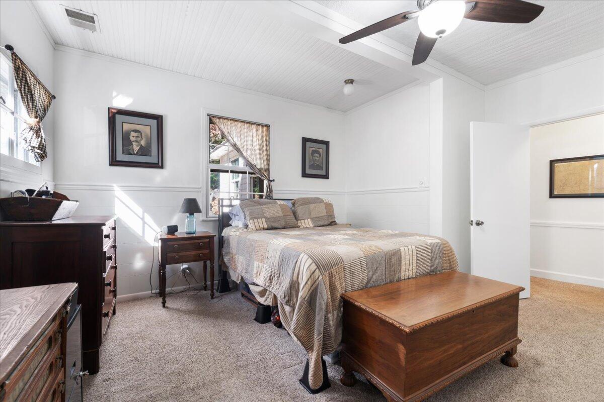 1017 Karnes Road Bedford, VA 24523 - Photo 26 of 56 a bedroom with a bed and a chandelier fan