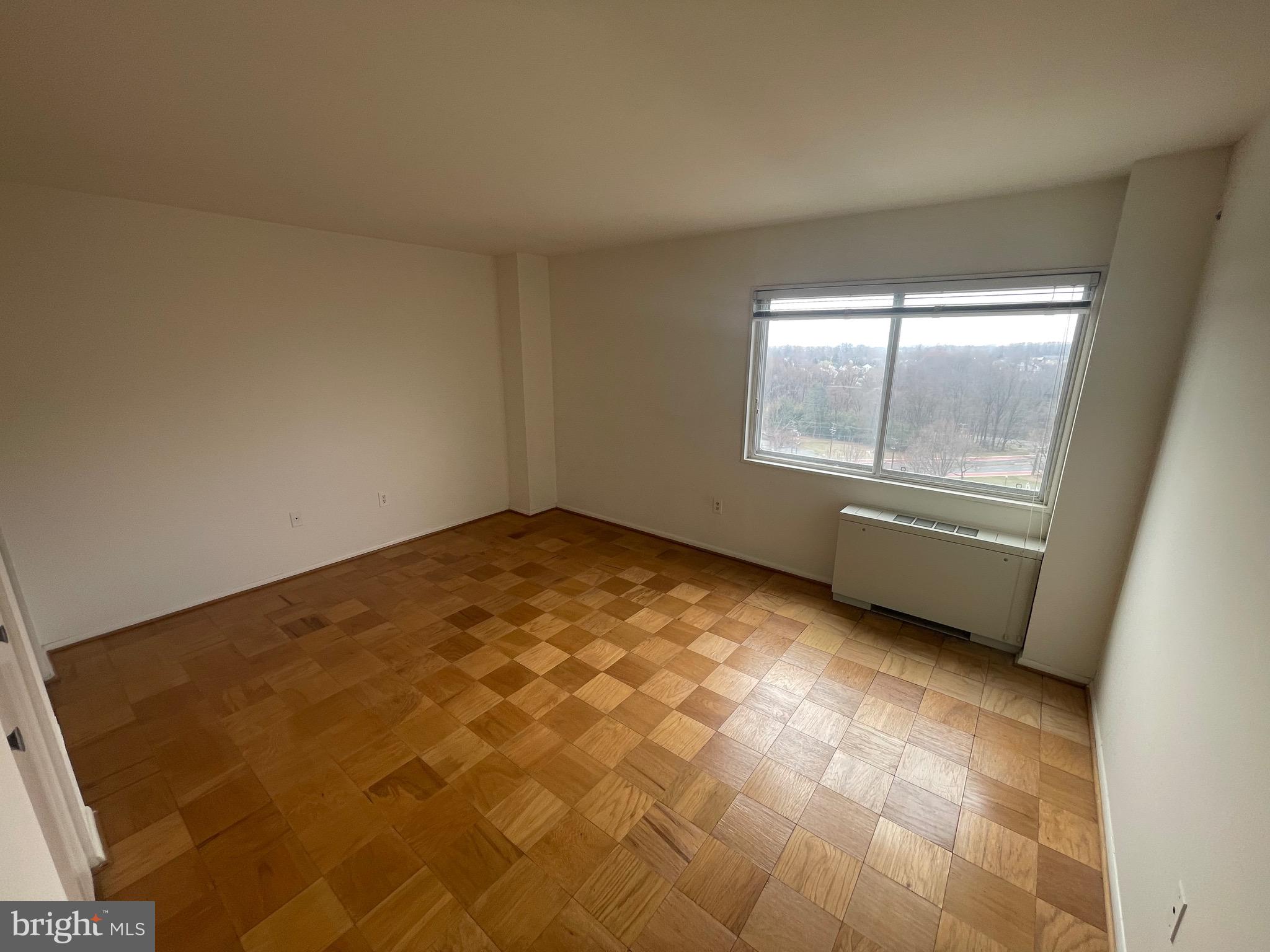 1111 University Boulevard West, Unit 1214A Silver Spring, MD 20902 - Photo 12 of 24 an empty room with windows