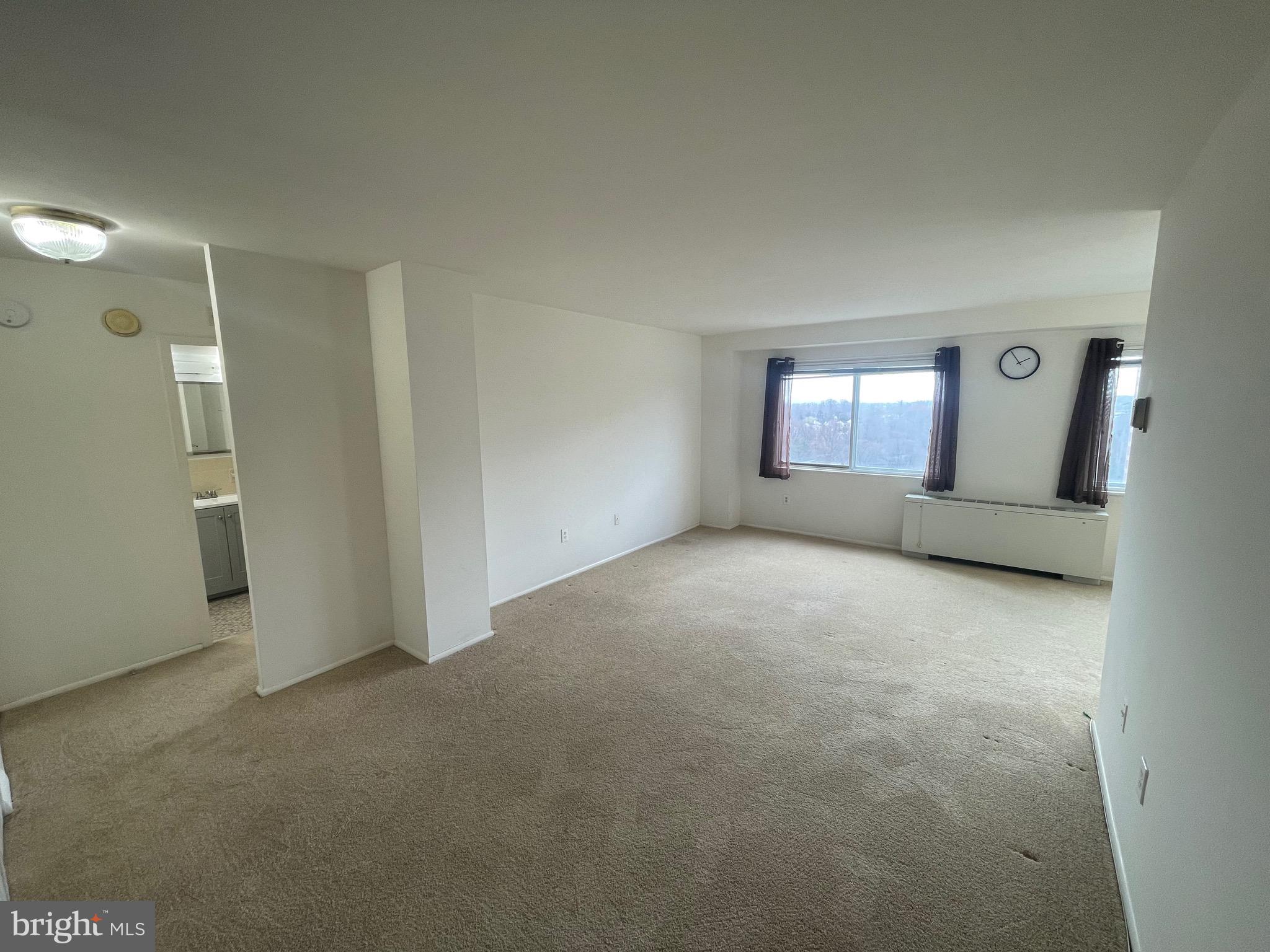 1111 University Boulevard West, Unit 1214A Silver Spring, MD 20902 - Photo 2 of 24 an empty room with a empty space and windows