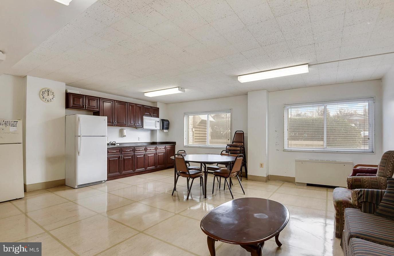 1111 University Boulevard West, Unit 1214A Silver Spring, MD 20902 - Photo 23 of 24 a dining room with furniture and window