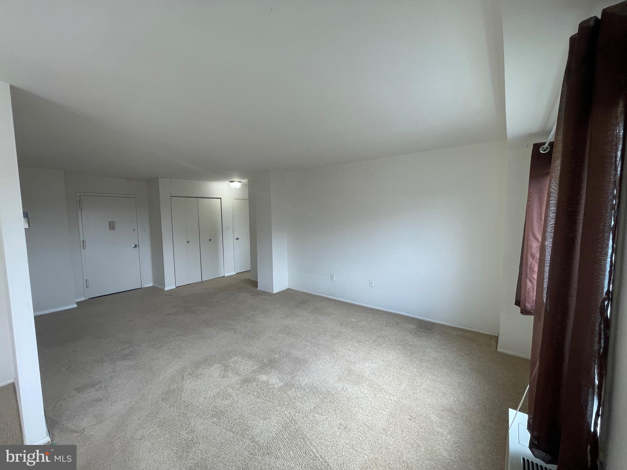 1111 University Boulevard West, Unit 1214A Silver Spring, MD 20902 - Photo 6 of 24 an empty room with a natural light