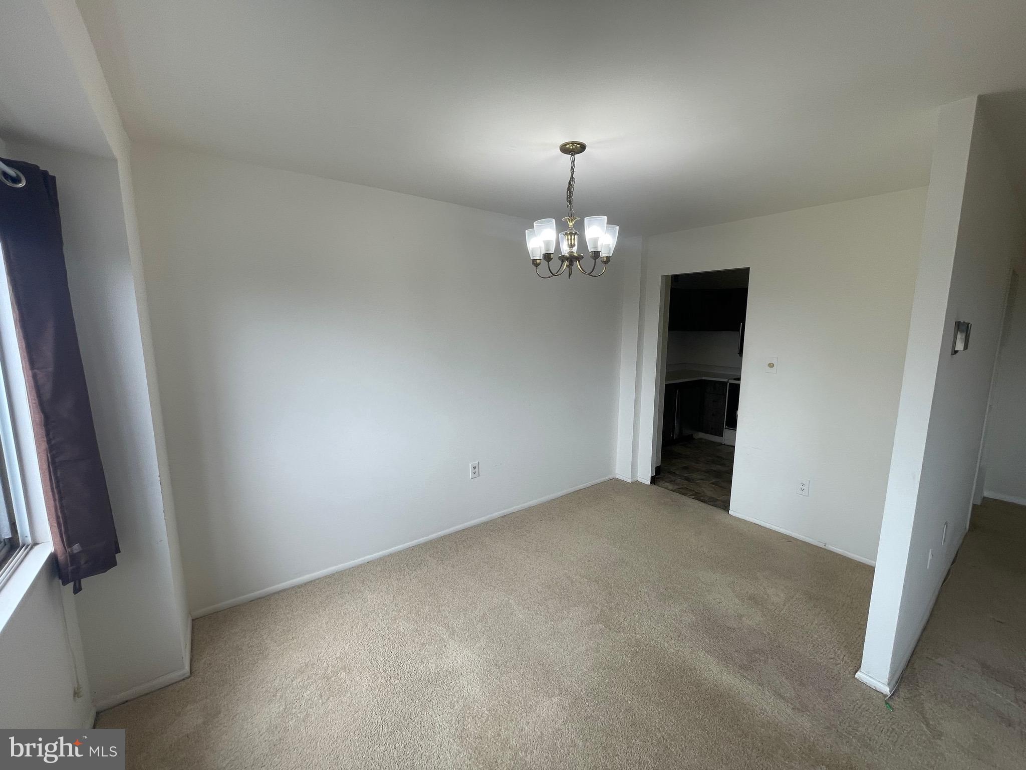 1111 University Boulevard West, Unit 1214A Silver Spring, MD 20902 - Photo 7 of 24 wooden floor in an empty room with a window