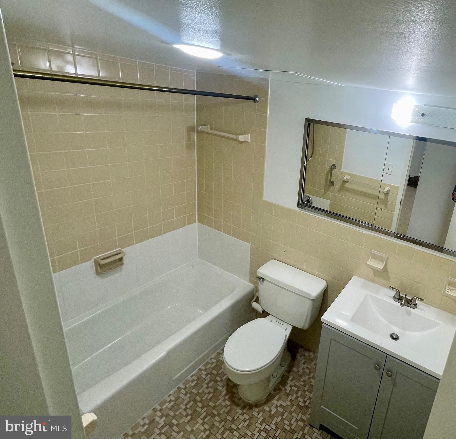 1111 University Boulevard West, Unit 1214A Silver Spring, MD 20902 - Photo 10 of 24 a bathroom with a sink toilet and shower
