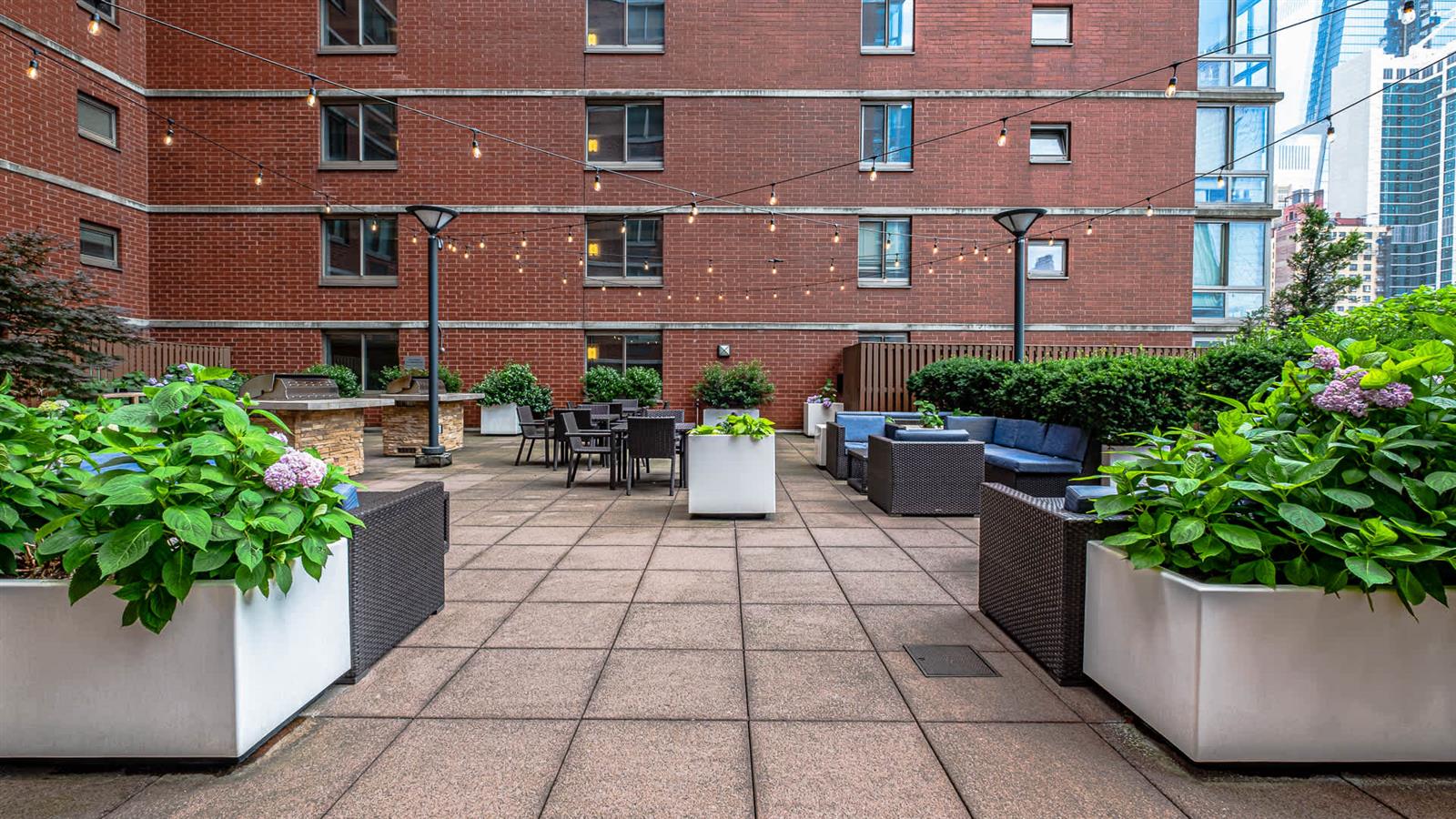 400 West 37th Street, Unit 15F Manhattan, NY 10018 - Photo 5 of 10 a view of a patio with plants and chairs