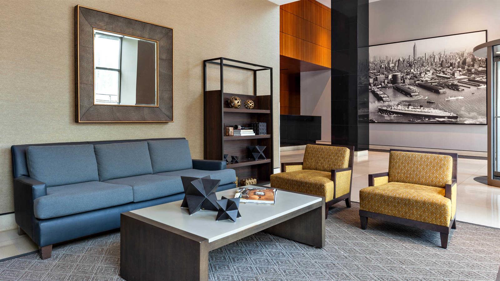 400 West 37th Street, Unit 15F Manhattan, NY 10018 - Photo 6 of 10 a living room with furniture and a painting on the wall