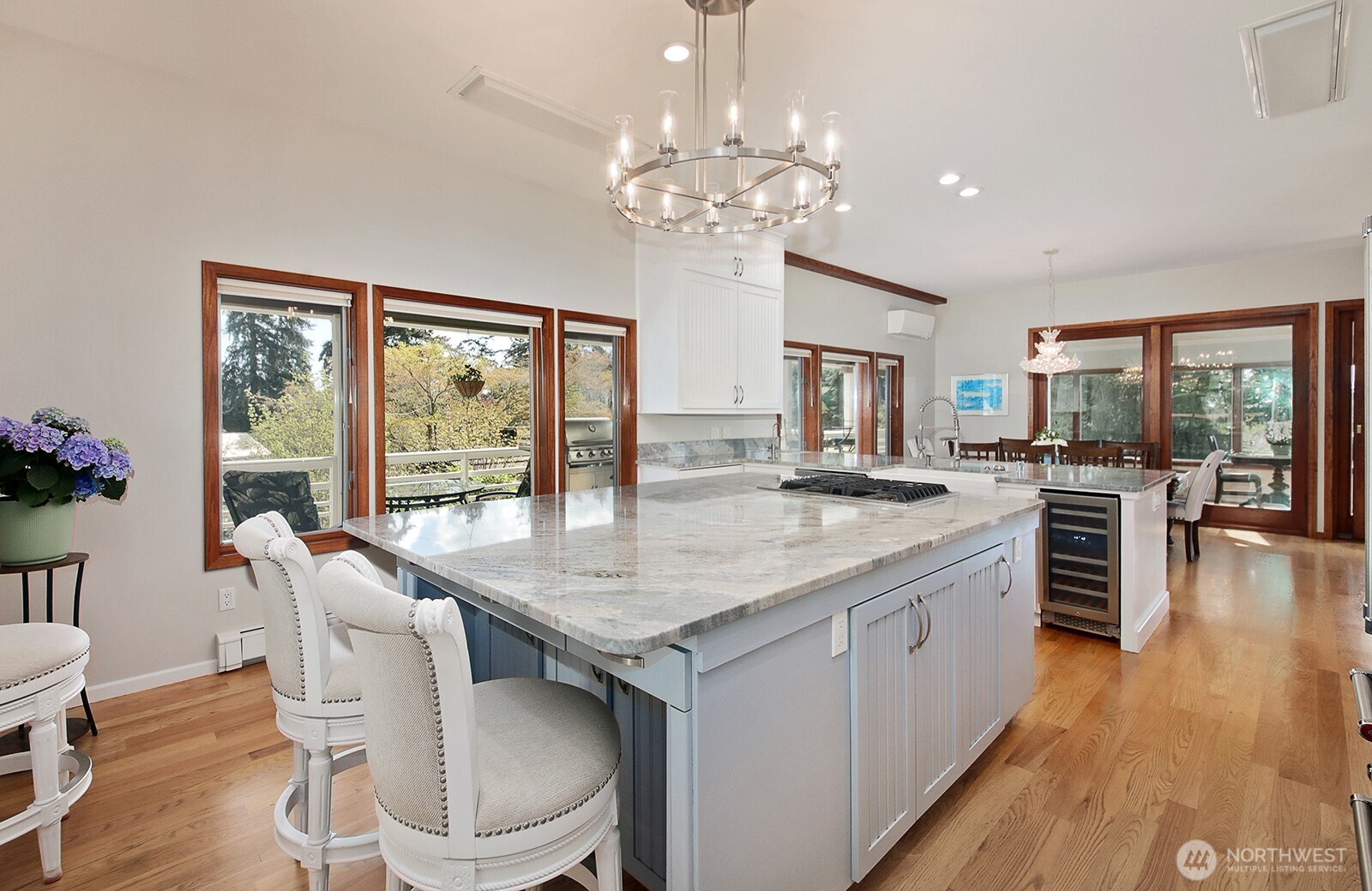 5741 Crow Haven Road Langley, WA 98260 - Photo 21 of 40 a open kitchen with stainless steel appliances granite countertop a kitchen island a stove a table and chairs in it