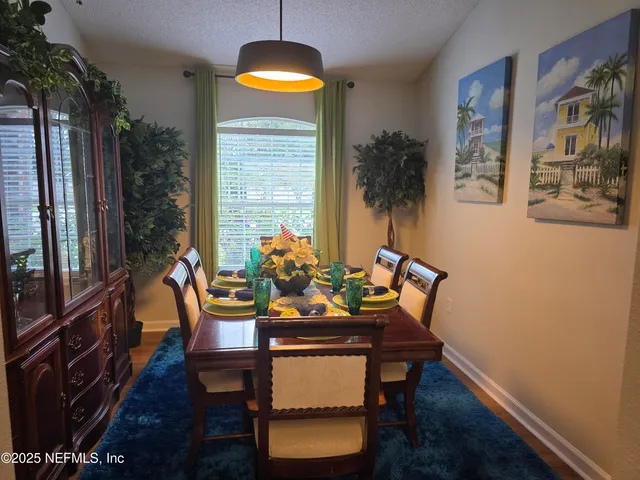 a view of a dining room with furniture window and wooden floor