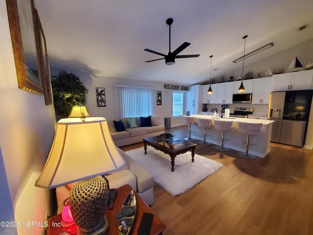a living room with furniture and a flat screen tv