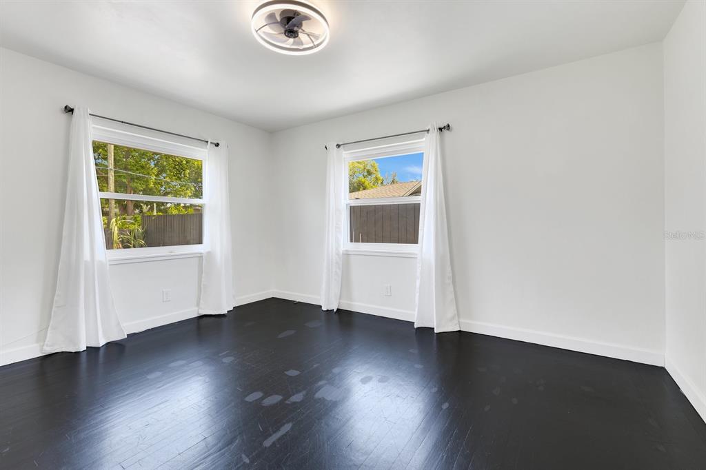 344 Starling Road Winter Park, FL 32789 - Photo 19 of 43 an empty room with wooden floor and windows