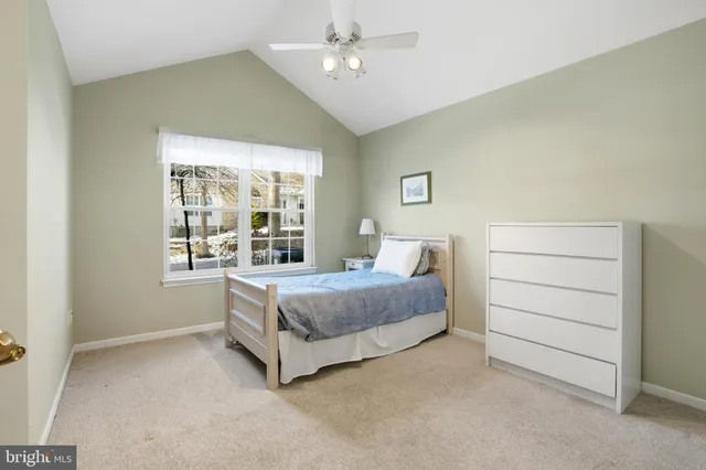 a spacious bedroom with a bed and a window