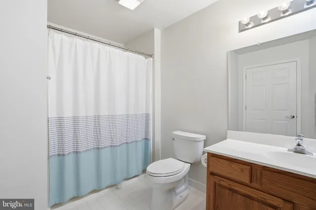 a white toilet sitting next to a bathroom sink