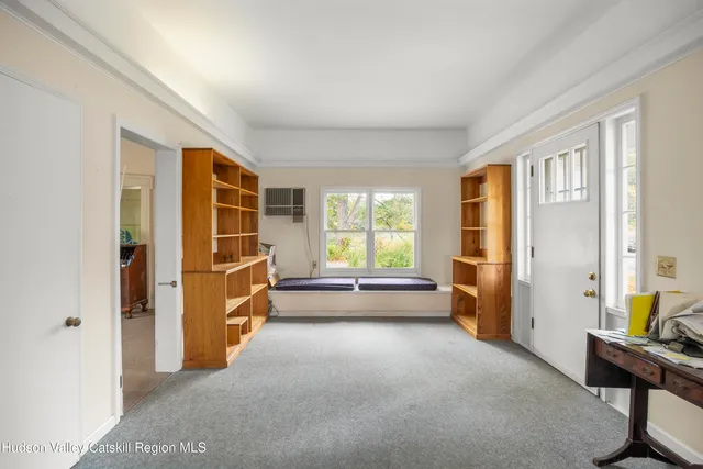 a view of empty room with a window and wooden floor