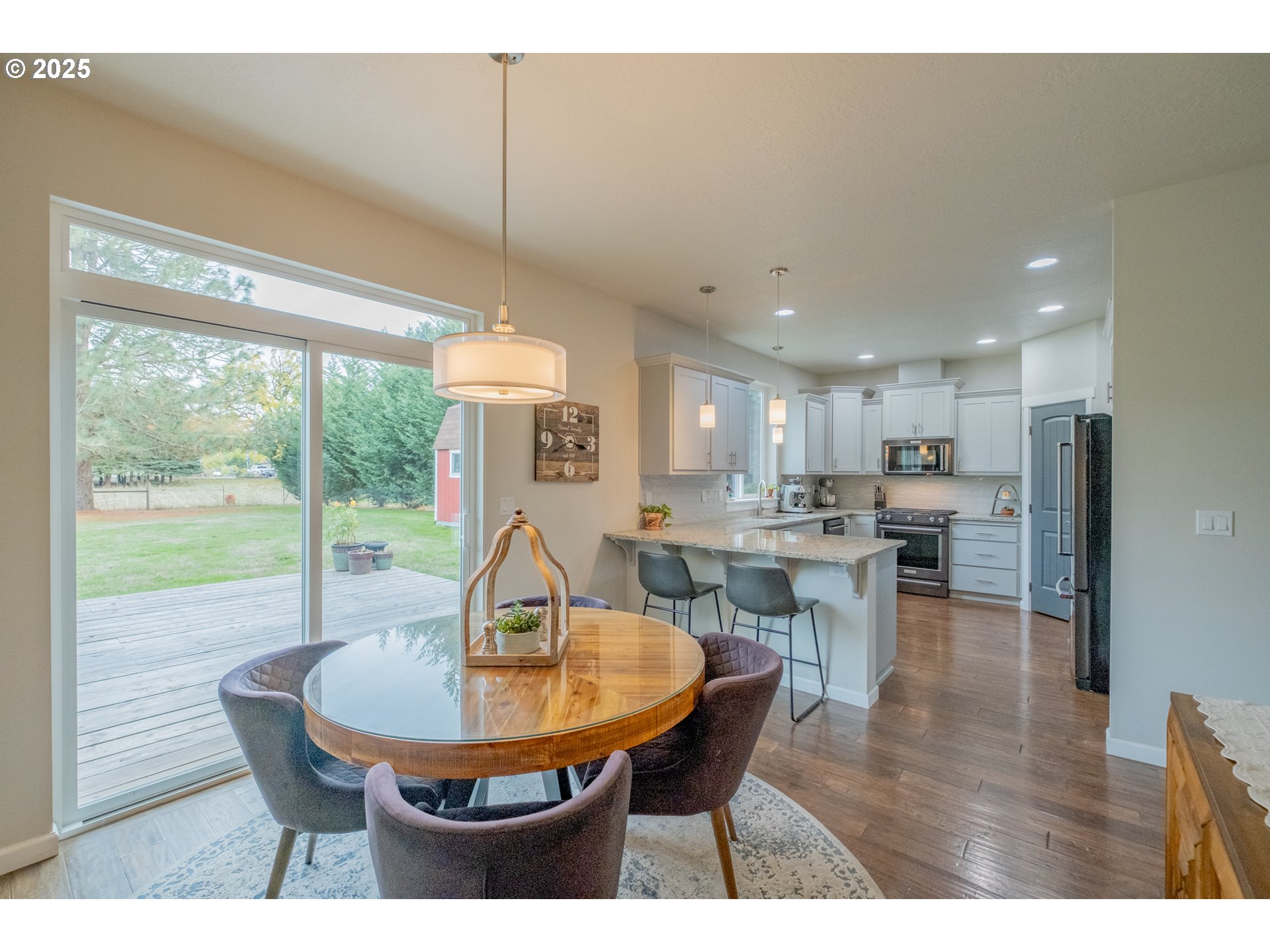405 Northwest Juniper Lane Albany, OR 97321 - Photo 10 of 48 a dining room with furniture wooden floor a rug a fireplace and a painting