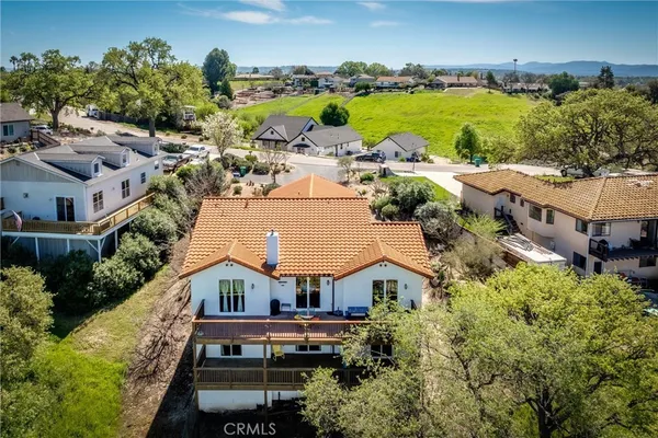 an aerial view of multiple houses with yard