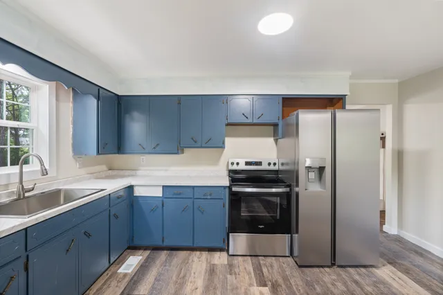 a kitchen with a sink stove and refrigerator