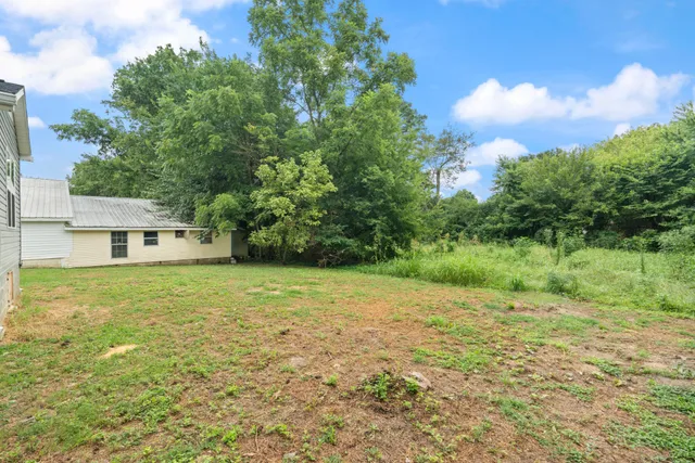 a view of a big yard with a house
