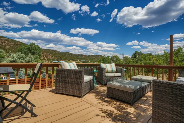 a view of a terrace with couches and wooden floor