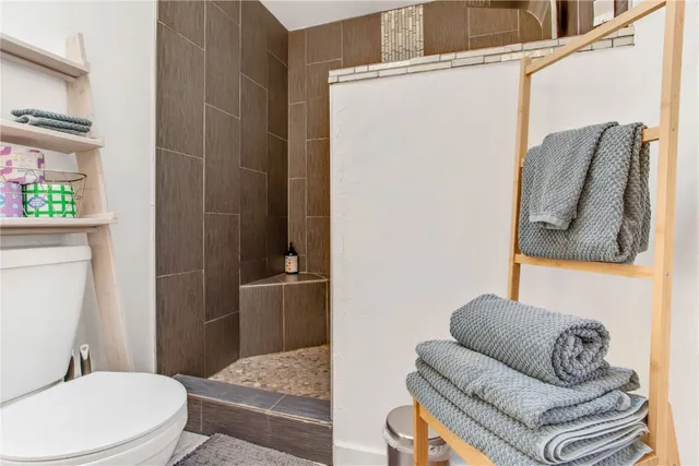 a bathroom with a toilet and shower