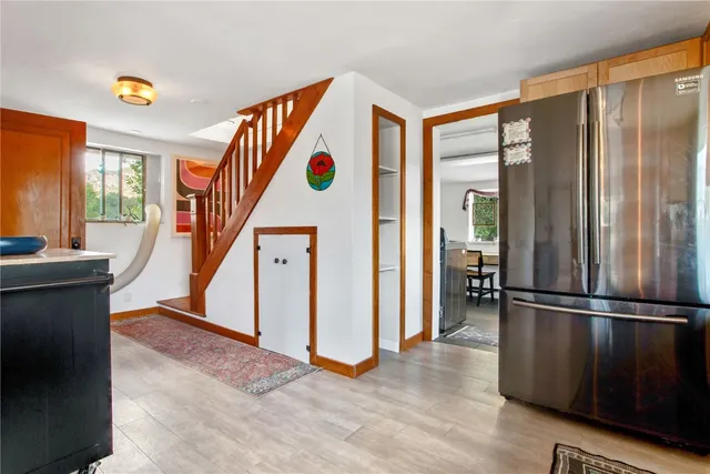 a view of hallway with furniture and a window