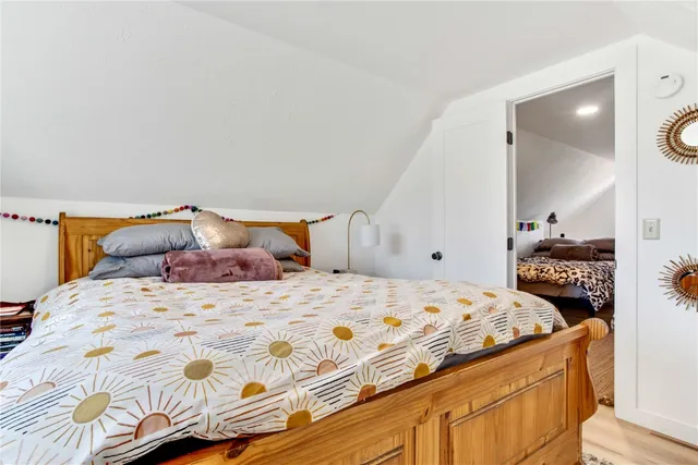 a bedroom with a bed and a mirror