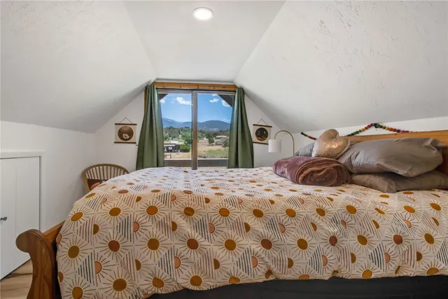 a bedroom with a large bed and a window