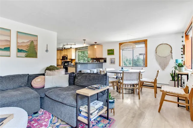 a living room with fireplace furniture and a large window